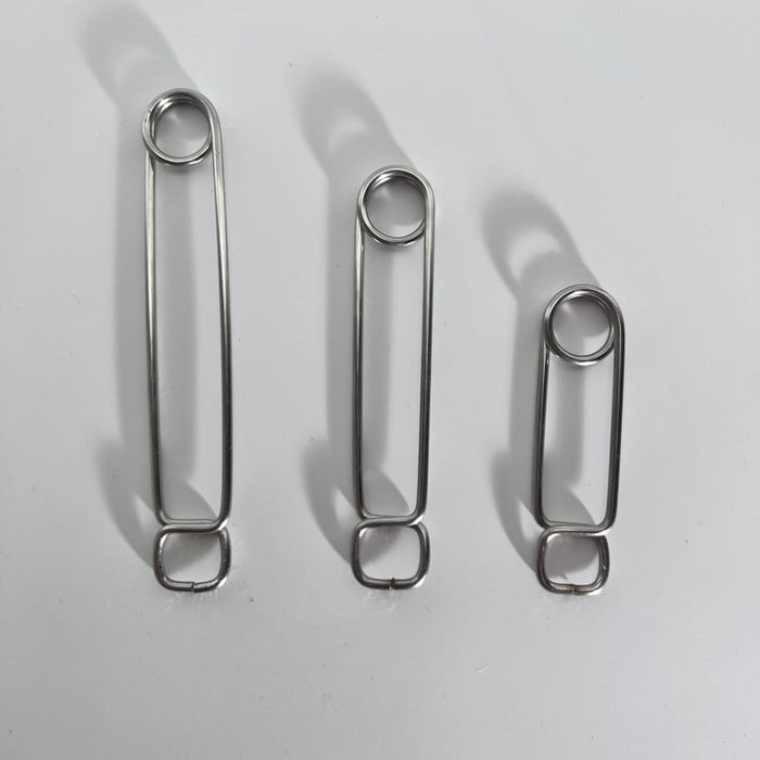 Three stainless steel roach clips of varying lengths in descending order